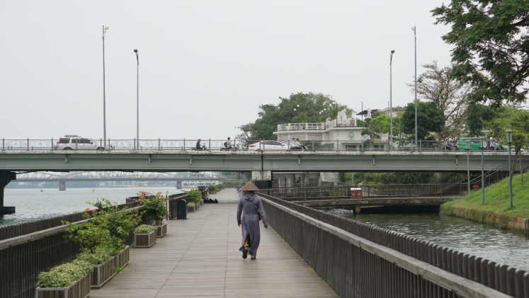 Vietnamese woman walking on a bridge