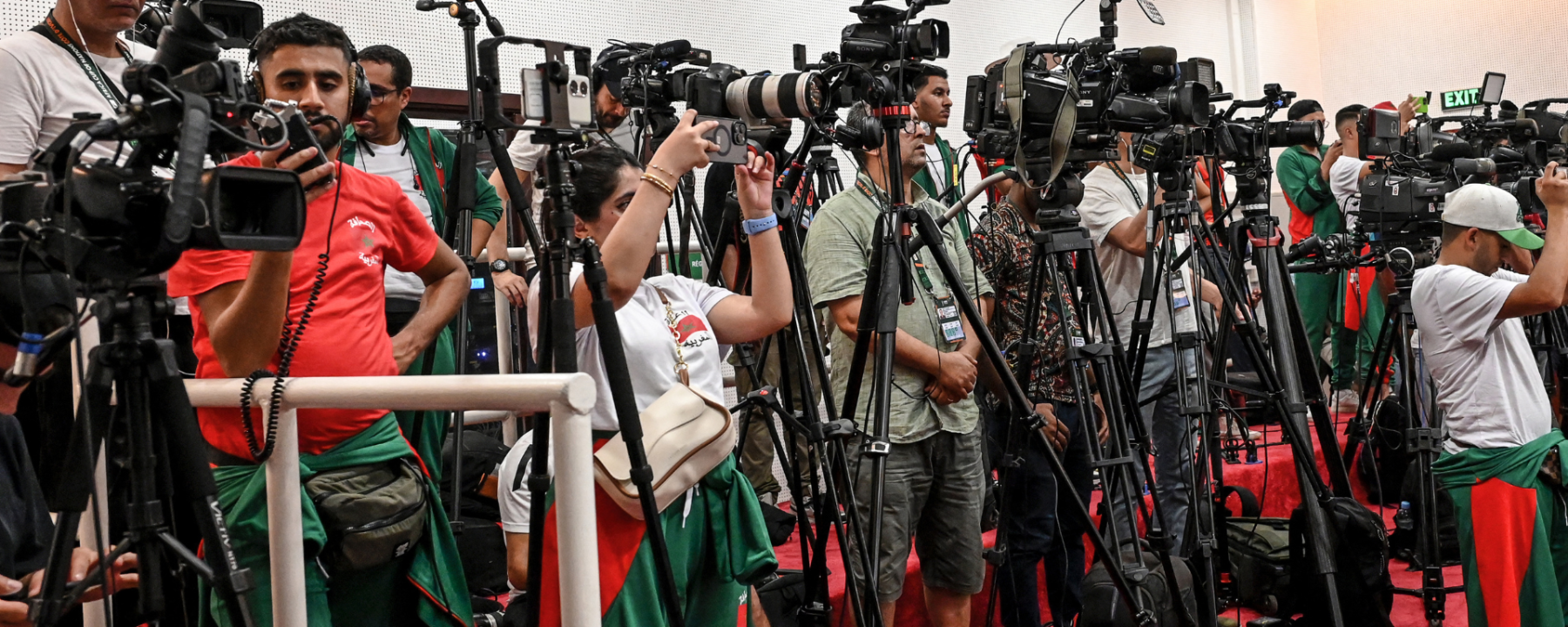 Journalists with cameras listening to a media briefing